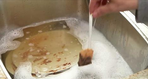 She Places A Tea Bag In A Sink Full Od Dirty Dishes